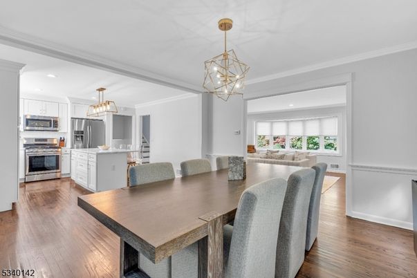 Chandelier, Dining room, Interior, Kitchen, Living room, Pendant Lights, Recessed Lighting, Stainless Steel Appliances, Wood Texture Flooring