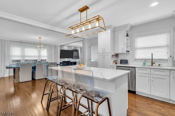 Chandelier, Dining room, Interior, Kitchen, Pendant Lights, Recessed Lighting, Stainless Steel Appliances, Wood Texture Flooring