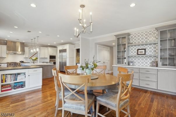 Chandelier, Dining room, Interior, Kitchen, Pendant Lights, Recessed Lighting, Stainless Steel Appliances, Wood Texture Flooring