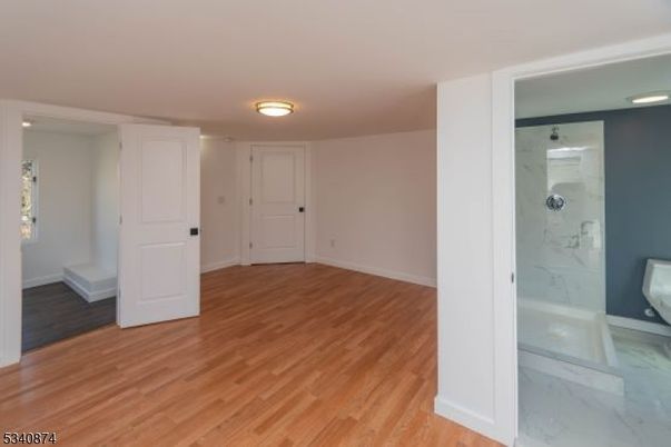 Bathroom, Empty room, Glass Shower, Interior, Marble, Marble Walls, Recessed Lighting, Wood Texture Flooring