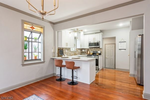 Chandelier, Interior, Kitchen, Pendant Lights, Recessed Lighting, Stainless Steel Appliances, Wood Texture Flooring