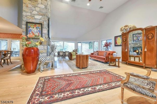 Dining room, Fireplace, Interior, Living room, Recessed Lighting, Stone Walls, Wood Texture Flooring