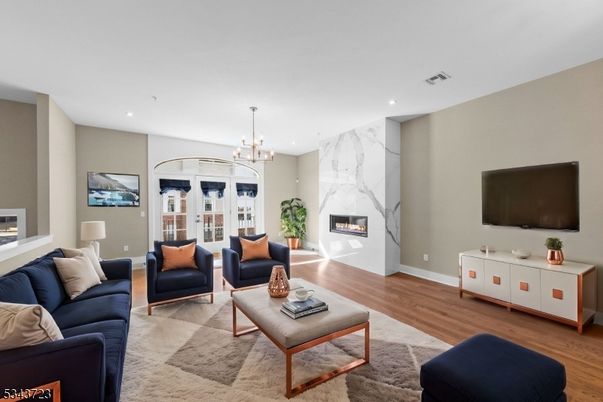 Chandelier, Fireplace, Interior, Living room, Marble Walls, Recessed Lighting, Wood Texture Flooring