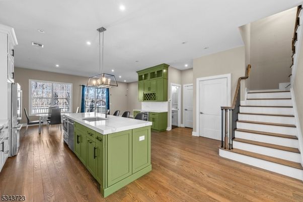 Chandelier, Dining room, Interior, Kitchen, Pendant Lights, Recessed Lighting, Stainless Steel Appliances, Wood Texture Flooring