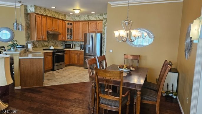 Chandelier, Dining room, Interior, Kitchen, Pendant Lights, Recessed Lighting, Stainless Steel Appliances, Wood Texture Flooring