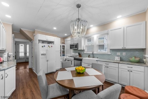 Chandelier, Dining room, Interior, Kitchen, Recessed Lighting, Stainless Steel Appliances, Wood Texture Flooring