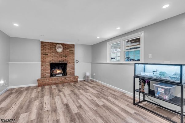 Empty room, Fireplace, Interior, Recessed Lighting, Stone Walls, Wood Texture Flooring