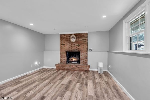 Empty room, Fireplace, Interior, Recessed Lighting, Stone Walls, Wood Texture Flooring