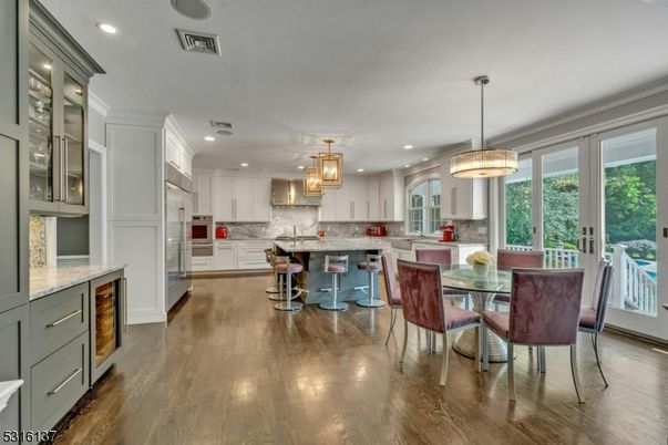 Chandelier, Dining room, Interior, Kitchen, Pendant Lights, Recessed Lighting, Stainless Steel Appliances, Wood Texture Flooring