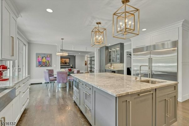 Chandelier, Dining room, Fireplace, Interior, Kitchen, Living room, Pendant Lights, Recessed Lighting, Stainless Steel Appliances, Wood Texture Flooring