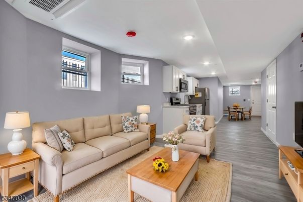 Dining room, Interior, Kitchen, Living room, Recessed Lighting, Stainless Steel Appliances, Wood Texture Flooring