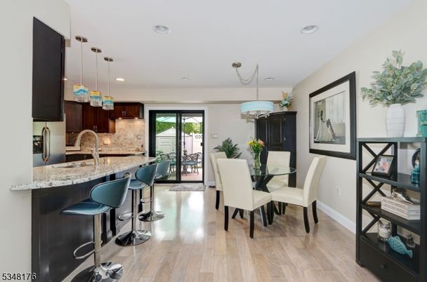 Chandelier, Dining room, Interior, Kitchen, Pendant Lights, Recessed Lighting, Stainless Steel Appliances, Wood Texture Flooring