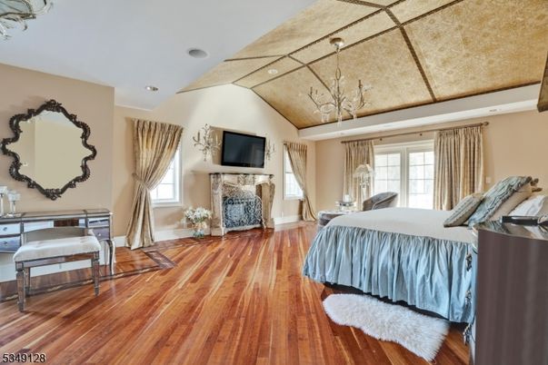 Bedroom, Chandelier, Fireplace, Interior, Recessed Lighting, Wood Texture Flooring
