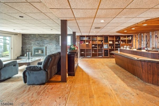 Fireplace, Interior, Living room, Recessed Lighting, Stone Walls, Wood Texture Flooring