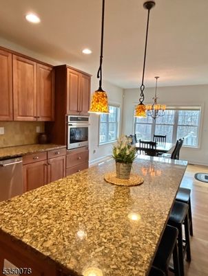 Chandelier, Dining room, Interior, Kitchen, Pendant Lights, Recessed Lighting, Stainless Steel Appliances, Wood Texture Flooring