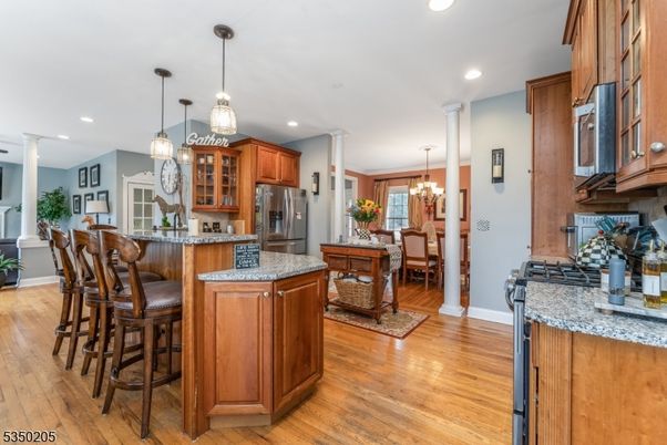 Chandelier, Dining room, Interior, Kitchen, Pendant Lights, Recessed Lighting, Stainless Steel Appliances, Wood Texture Flooring