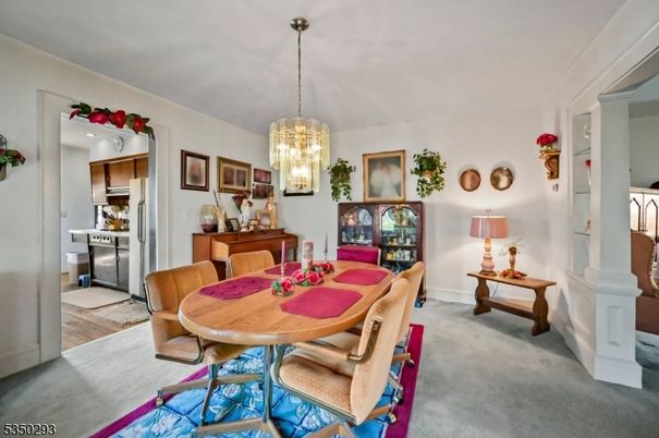 Chandelier, Dining room, Interior, Kitchen, Pendant Lights, Stainless Steel Appliances, Wood Texture Flooring