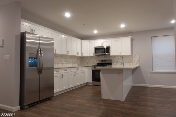 Interior, Kitchen, Marble Walls, Recessed Lighting, Stainless Steel Appliances, Wood Texture Flooring