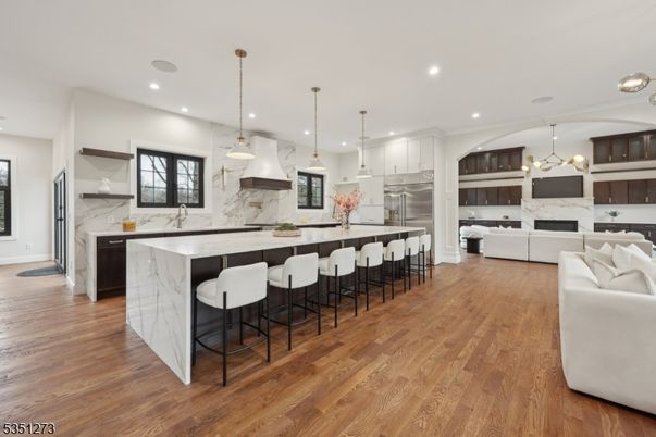 Fireplace, Interior, Kitchen, Living room, Marble Walls, Pendant Lights, Recessed Lighting, Stainless Steel Appliances, Wood Texture Flooring