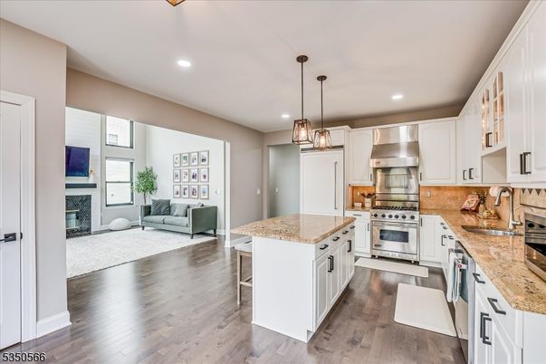 Fireplace, Interior, Kitchen, Living room, Pendant Lights, Recessed Lighting, Stainless Steel Appliances, Wood Texture Flooring