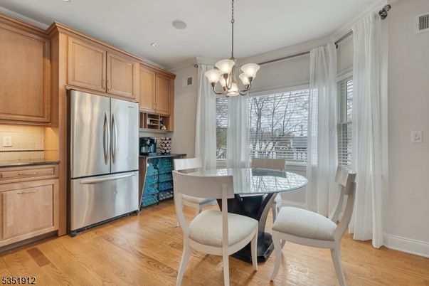 Chandelier, Dining room, Interior, Kitchen, Pendant Lights, Recessed Lighting, Stainless Steel Appliances, Wood Texture Flooring