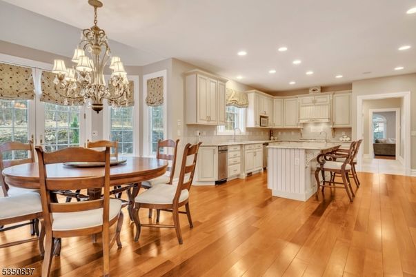 Chandelier, Dining room, Interior, Kitchen, Recessed Lighting, Stainless Steel Appliances, Wood Texture Flooring