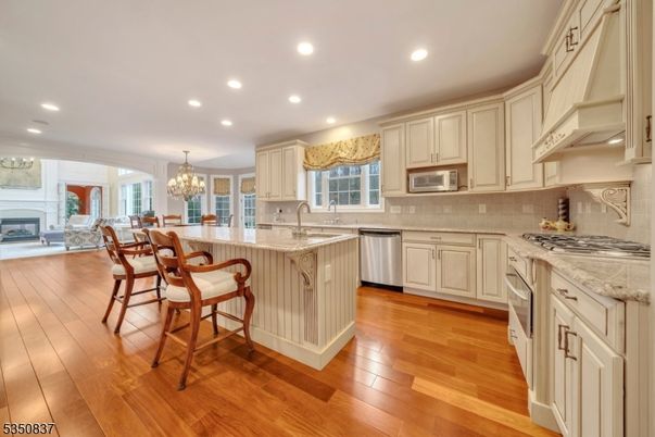 Chandelier, Dining room, Fireplace, Interior, Kitchen, Recessed Lighting, Stainless Steel Appliances, Wood Texture Flooring