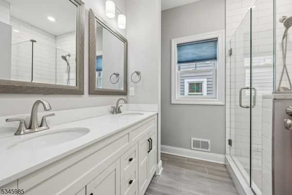 Bathroom, Dual Sink Vanities, Glass Shower, Interior, Recessed Lighting, Wood Texture Flooring