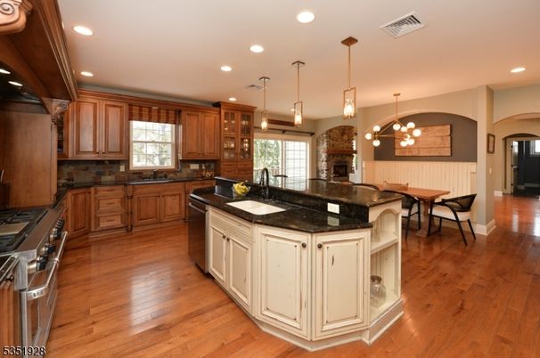 Dining room, Fireplace, Interior, Kitchen, Pendant Lights, Recessed Lighting, Stainless Steel Appliances, Wood Texture Flooring
