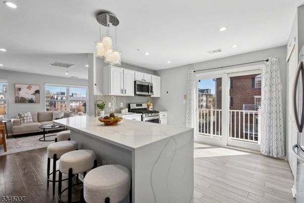 Chandelier, Interior, Kitchen, Living room, Pendant Lights, Recessed Lighting, Stainless Steel Appliances, Wood Texture Flooring