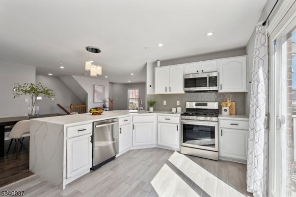 Chandelier, Dining room, Interior, Kitchen, Pendant Lights, Recessed Lighting, Stainless Steel Appliances, Wood Texture Flooring