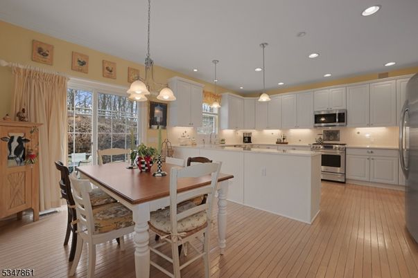 Dining room, Interior, Kitchen, Pendant Lights, Recessed Lighting, Stainless Steel Appliances, Wood Texture Flooring