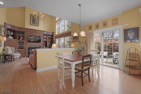 Chandelier, Dining room, Fireplace, Interior, Living room, Pendant Lights, Recessed Lighting, Wood Texture Flooring