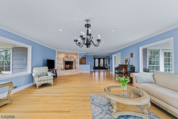 Chandelier, Fireplace, Interior, Living room, Piano, Recessed Lighting, Wood Texture Flooring
