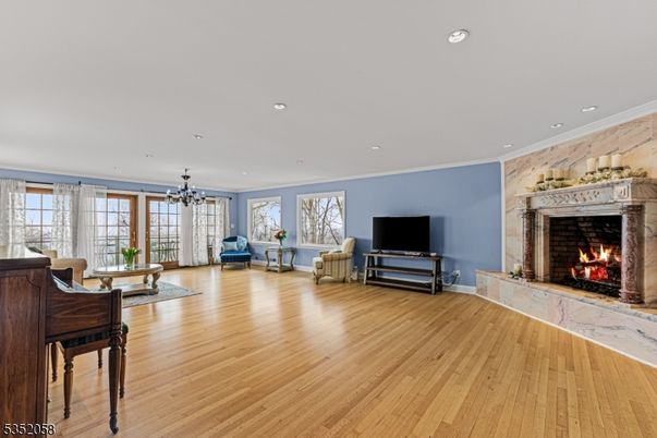 Chandelier, Fireplace, Interior, Living room, Piano, Recessed Lighting, Wood Texture Flooring