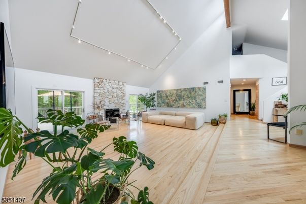 Fireplace, Interior, Living room, Recessed Lighting, Stone Walls, Wood Texture Flooring