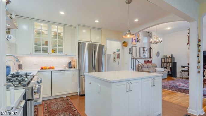 Chandelier, Dining room, Interior, Kitchen, Pendant Lights, Recessed Lighting, Stainless Steel Appliances, Wood Texture Flooring