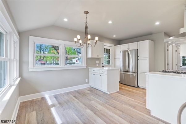 Chandelier, Interior, Kitchen, Pendant Lights, Recessed Lighting, Stainless Steel Appliances, Wood Texture Flooring