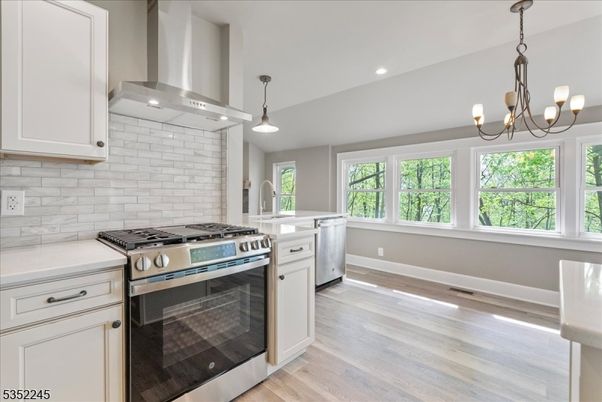 Chandelier, Interior, Kitchen, Pendant Lights, Recessed Lighting, Stainless Steel Appliances, Wood Texture Flooring