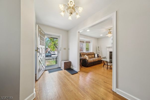 Chandelier, Fireplace, Interior, Living room, Recessed Lighting, Wood Texture Flooring