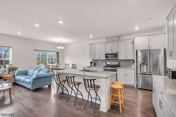 Chandelier, Dining room, Interior, Kitchen, Living room, Recessed Lighting, Stainless Steel Appliances, Wood Texture Flooring