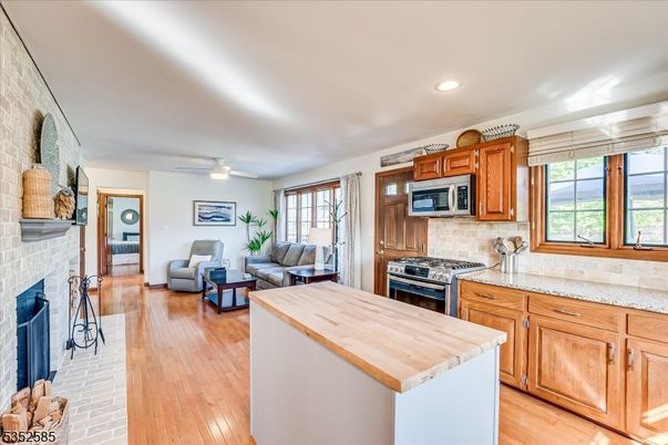 Fireplace, Interior, Kitchen, Living room, Recessed Lighting, Stone Walls, Wood Texture Flooring