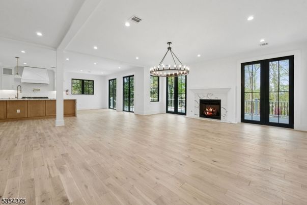 Chandelier, Empty room, Fireplace, Interior, Kitchen, Pendant Lights, Recessed Lighting, Wood Texture Flooring
