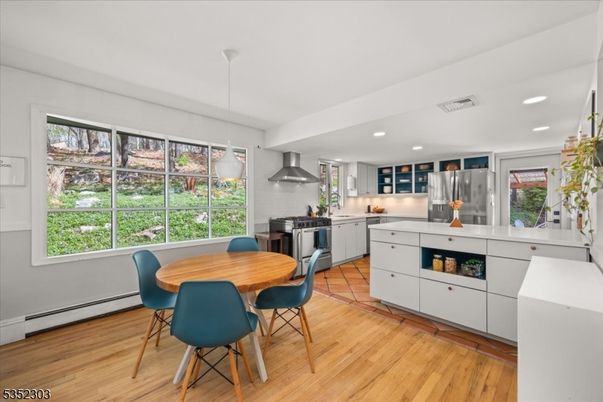 Dining room, Interior, Kitchen, Pendant Lights, Recessed Lighting, Stainless Steel Appliances, Wood Texture Flooring