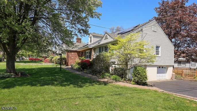 Attached, Backyard, Exterior, Facade, Brick Facade, Solar Panels, Tudor Revival