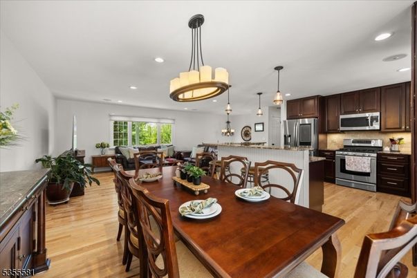 Chandelier, Dining room, Interior, Kitchen, Pendant Lights, Recessed Lighting, Stainless Steel Appliances, Wood Texture Flooring