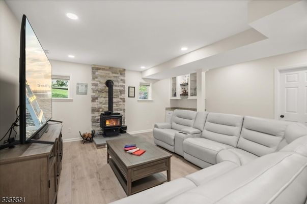 Fireplace, Interior, Living room, Recessed Lighting, Stone Walls, Wood Texture Flooring