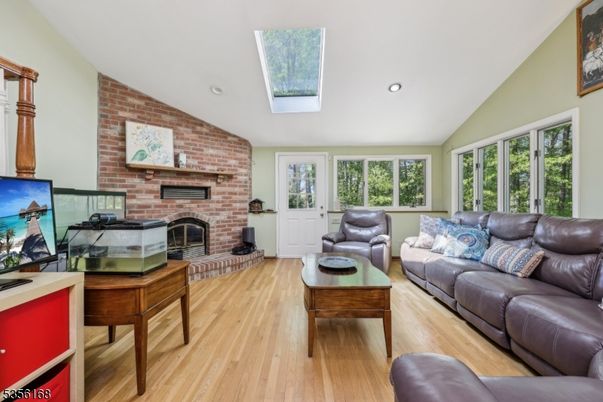 Fireplace, Interior, Living room, Recessed Lighting, Stone Walls, Wood Texture Flooring