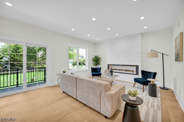Fireplace, Interior, Living room, Recessed Lighting, Stone Walls, Wood Texture Flooring