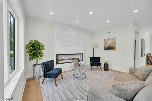 Fireplace, Interior, Living room, Recessed Lighting, Stone Walls, Wood Texture Flooring